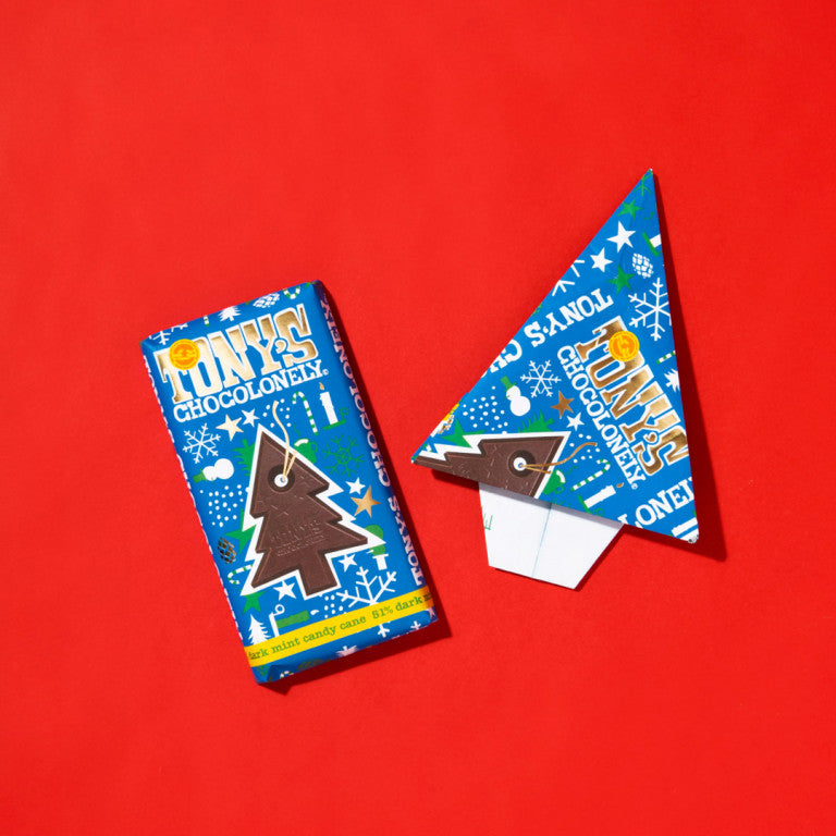 Tony's Chocolonely Christmas bar and Christmas wrapper in shape of a paper airplane.